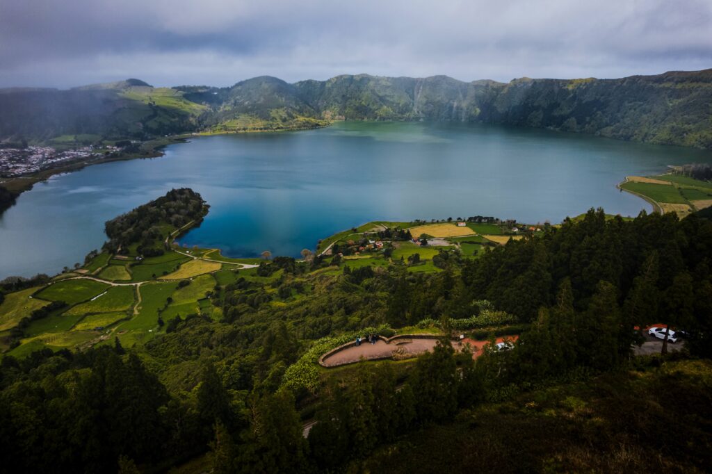 Panoramic view of Sete Cidades Lake surrounded by the green slopes of its volcanic crater in São Miguel.