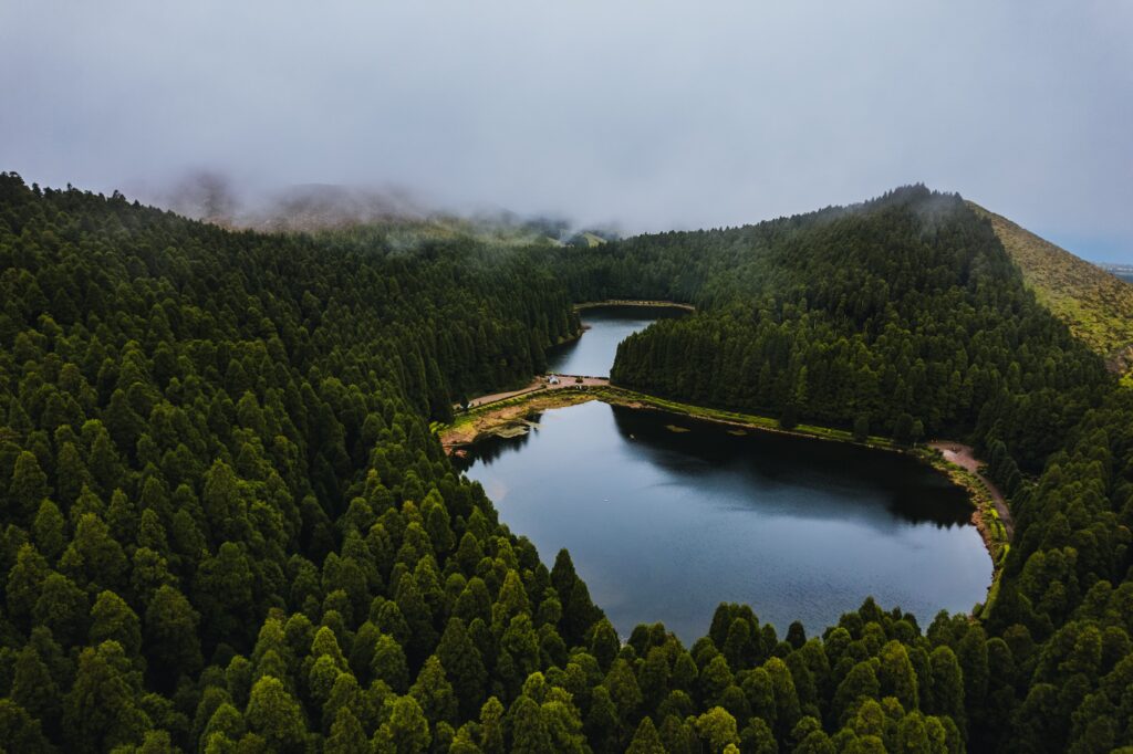 Sete Cidades Lake viewed from a viewpoint, surrounded by the green landscape of São Miguel's volcanic crater.