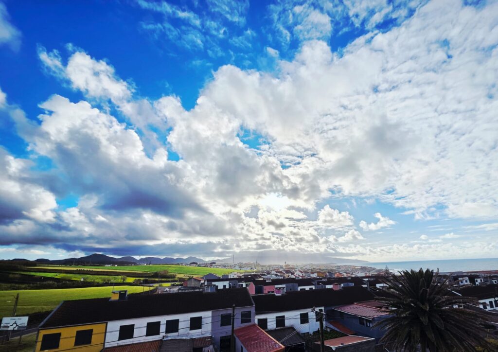 Coastal view of Rabo de Peixe in São Miguel, with cliffs, traditional houses and the Atlantic Ocean.