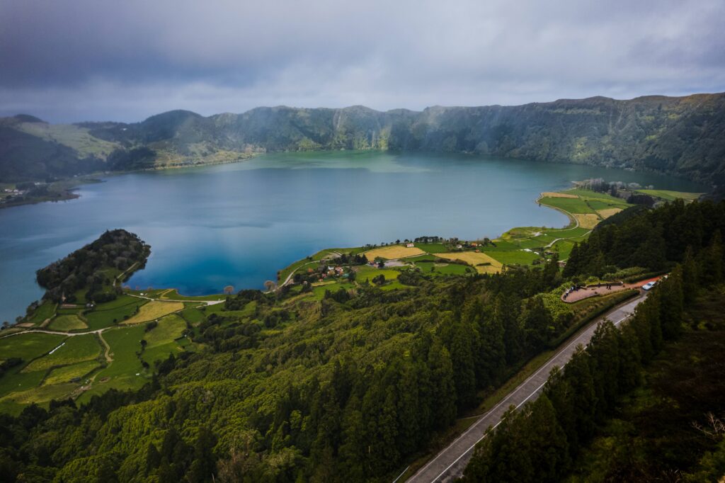 Aerial view of a volcanic lagoon in São Miguel with ocean in the background